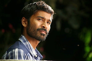Dhanush in a contemplative outdoor portrait wearing a blue plaid shirt HD wallpaper