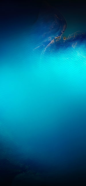 Aerial View of Turquoise Ocean and Coastal Landmass with Deep Blue Gradient HD phone wallpaper