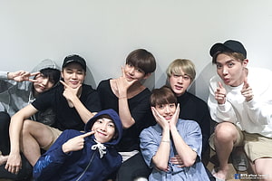 BTS Group Photo: Seven Members Posing Playfully Against a White Wall HD wallpaper