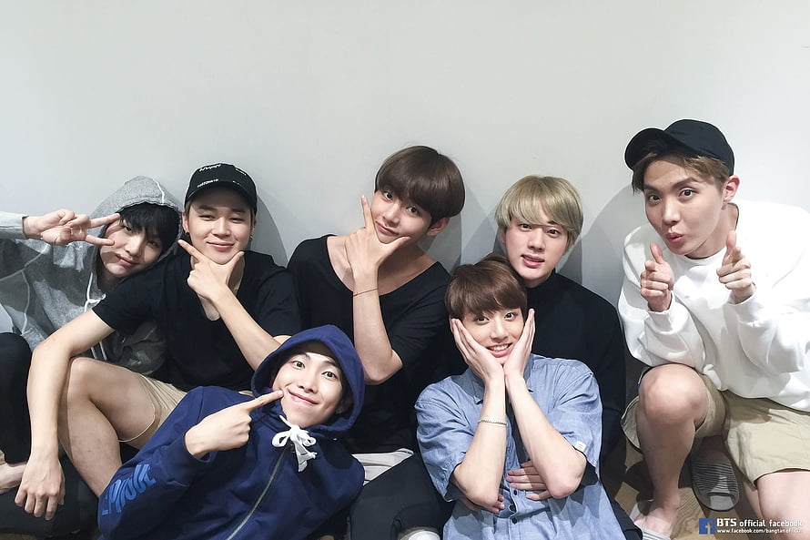 BTS Group Photo: Seven Members Posing Playfully Against a White Wall HD wallpaper