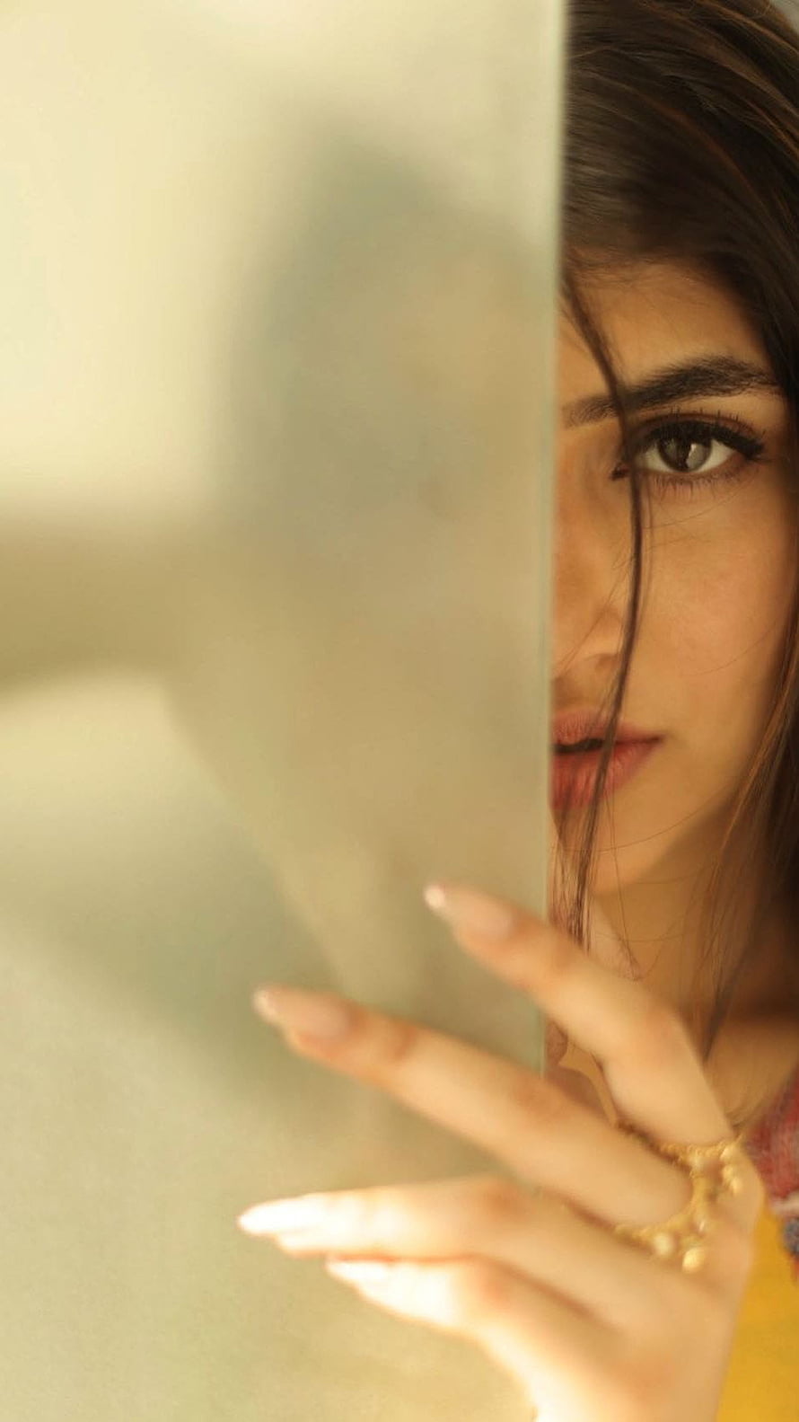 Sreeleela Peeking From Behind a Wall in Warm Golden Light HD phone wallpaper