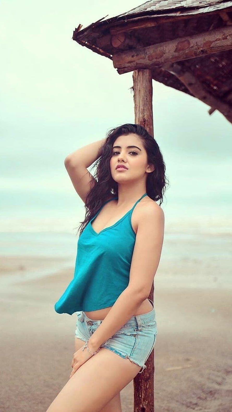 Malavika Sharma in Teal Tank Top and Denim Shorts at the Beach HD phone wallpaper