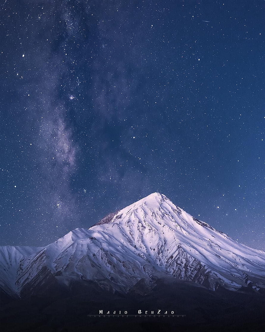 Milky Way Galaxy Arching Over Snow-Capped Mount Damavand in Iran at Night HD phone wallpaper