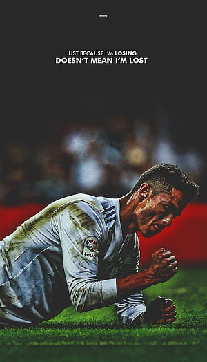 Cristiano Ronaldo kneeling on grass in Real Madrid jersey with motivational quote about perseverance HD phone wallpaper