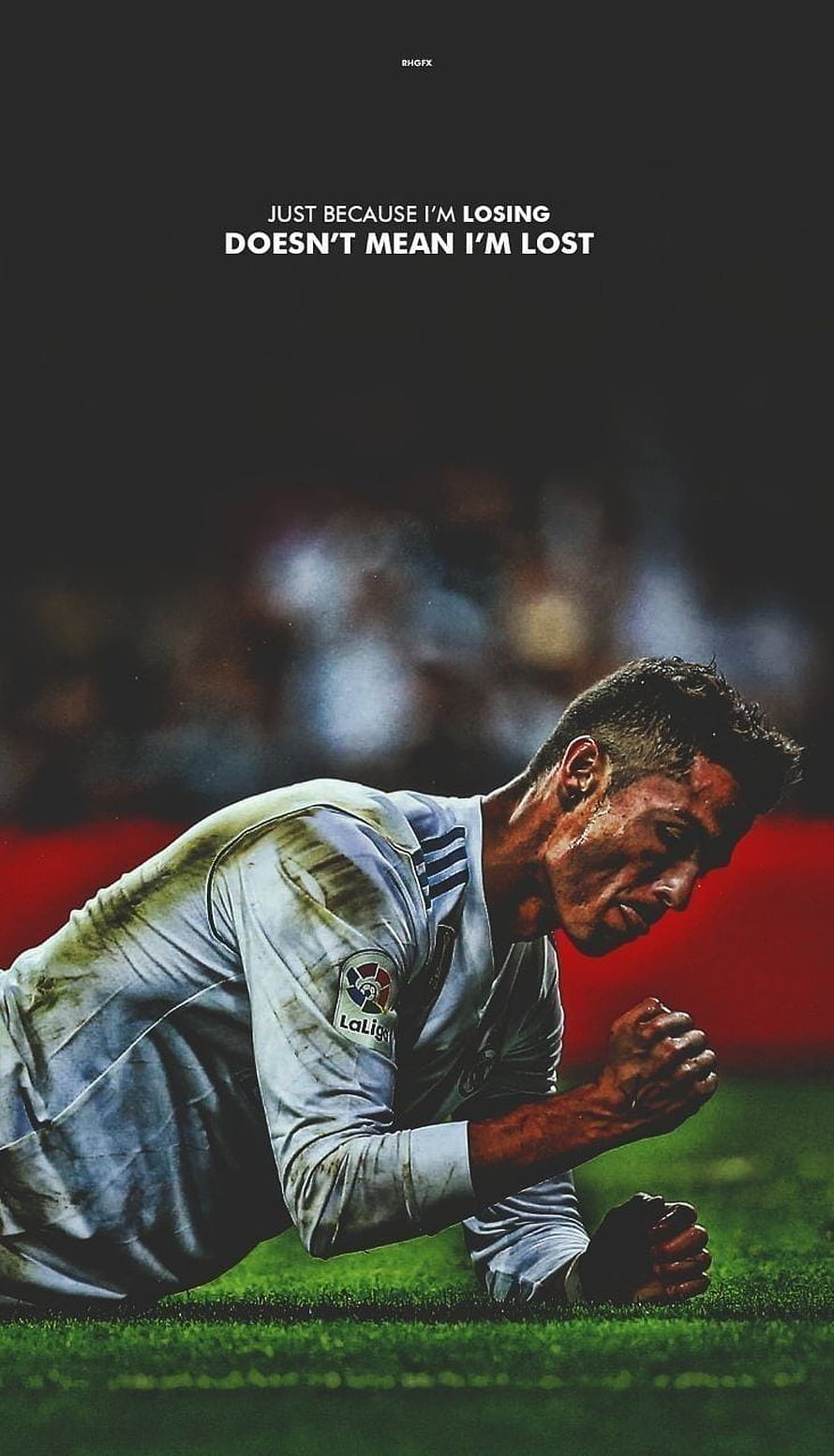 Cristiano Ronaldo kneeling on grass in Real Madrid jersey with motivational quote about perseverance HD phone wallpaper