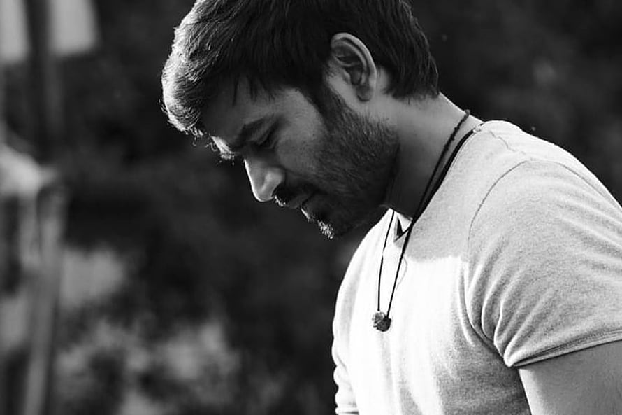 Dhanush in a contemplative black and white portrait with a pensive expression HD wallpaper