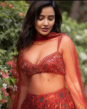 Neha Sharma in Red Embroidered Lehenga Choli with Floral Garden Backdrop HD phone wallpaper