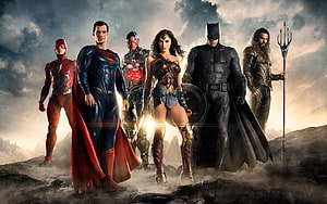 Justice League Heroes Standing Together on Rocky Terrain with Dramatic Sky HD wallpaper
