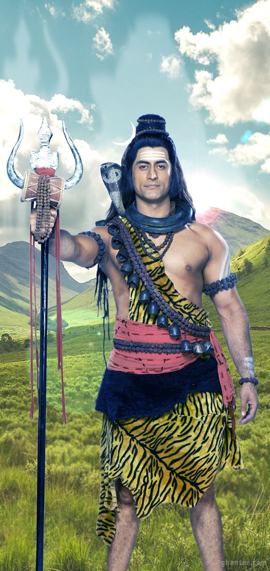 Lord Shiva in tiger skin holding trident and rudraksha beads in a green mountain landscape HD phone wallpaper