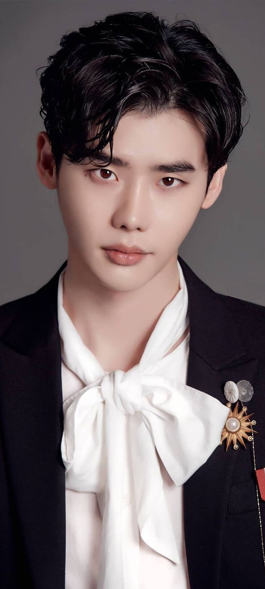 Lee Jong Suk in a black suit with a white bow tie and decorative brooch HD phone wallpaper