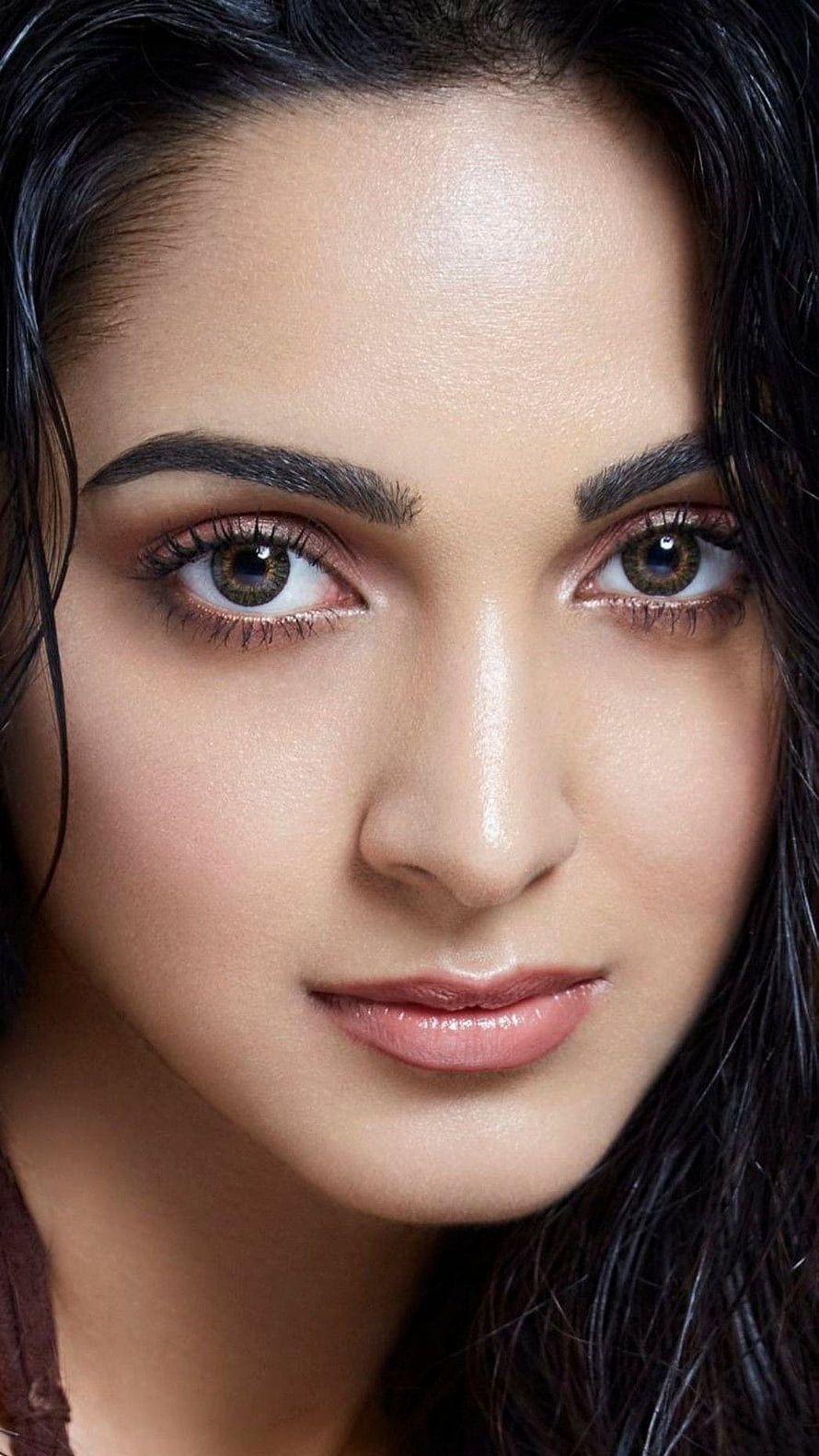 Close-up portrait of a woman with striking green eyes and dark hair, Kiara Advani, bollywood actress HD phone wallpaper