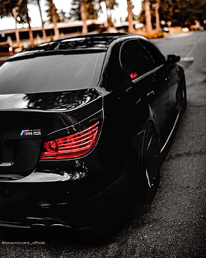 Rear Three-Quarter View of a Black BMW M5 E60 Sedan with Glossy Paint and Red Taillights HD phone wallpaper