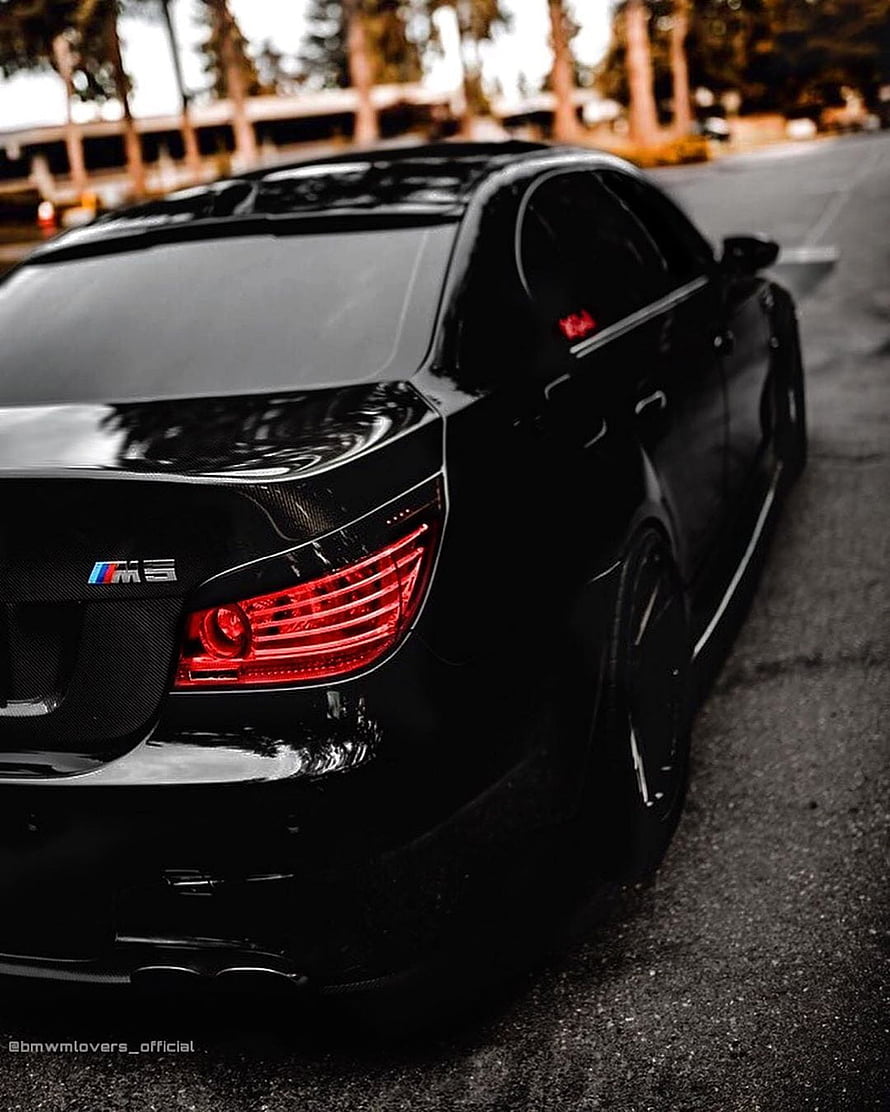 Rear Three-Quarter View of a Black BMW M5 E60 Sedan with Glossy Paint and Red Taillights HD phone wallpaper