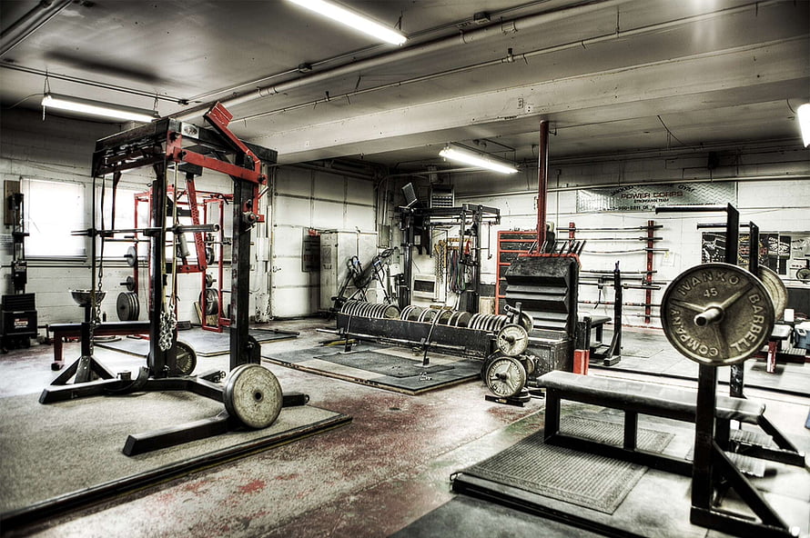 Industrial Strength Training Facility With Heavy Iron Equipment And Weight Plates HD wallpaper