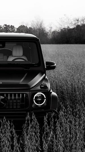 Matte Black Mercedes-Benz G-Class SUV in a Field HD phone wallpaper