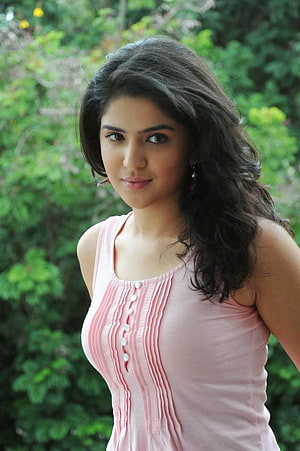 Sai Pallavi in a Pink Top with Wavy Hair and Green Background HD phone wallpaper