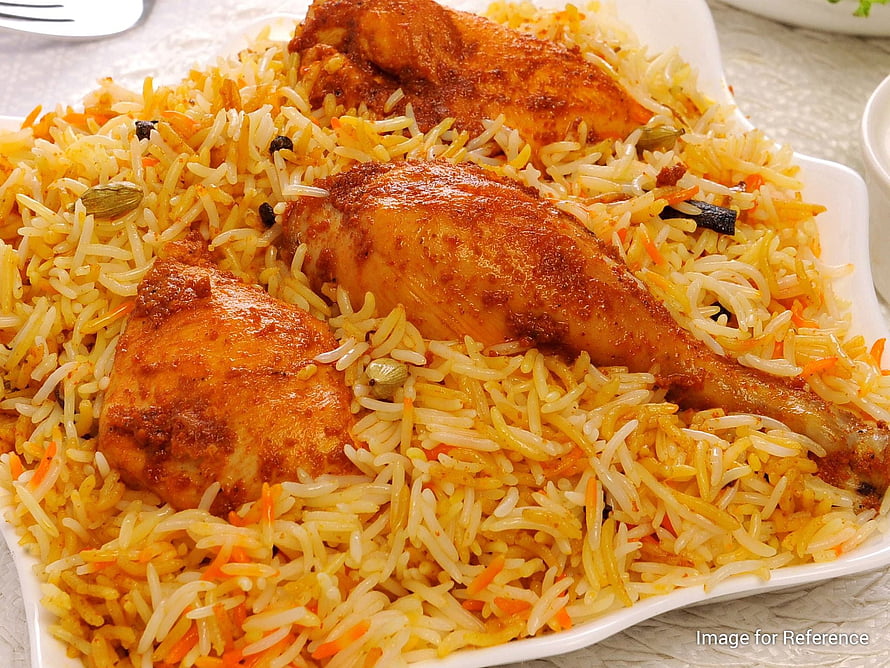 Golden Chicken Biryani with Saffron Rice, Carrots, and Whole Spices on a White Plate HD wallpaper