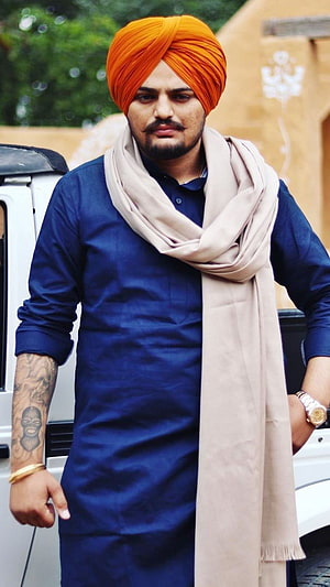 Diljit Dosanjh in a Blue Kurta and Orange Turban with Beige Shawl HD phone wallpaper
