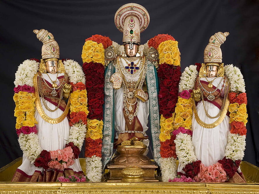 Hindu Deities Adorned in Gold Jewelry and Colorful Flower Garlands HD wallpaper
