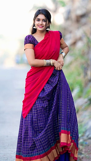 Sanjana Anand in a vibrant red and purple checkered saree with traditional gold bangles HD phone wallpaper