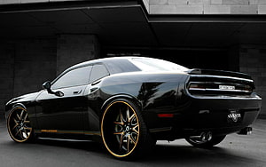 Black Dodge Challenger SRT8 Asanti with Gold-Rimmed Wheels in Urban Setting HD wallpaper