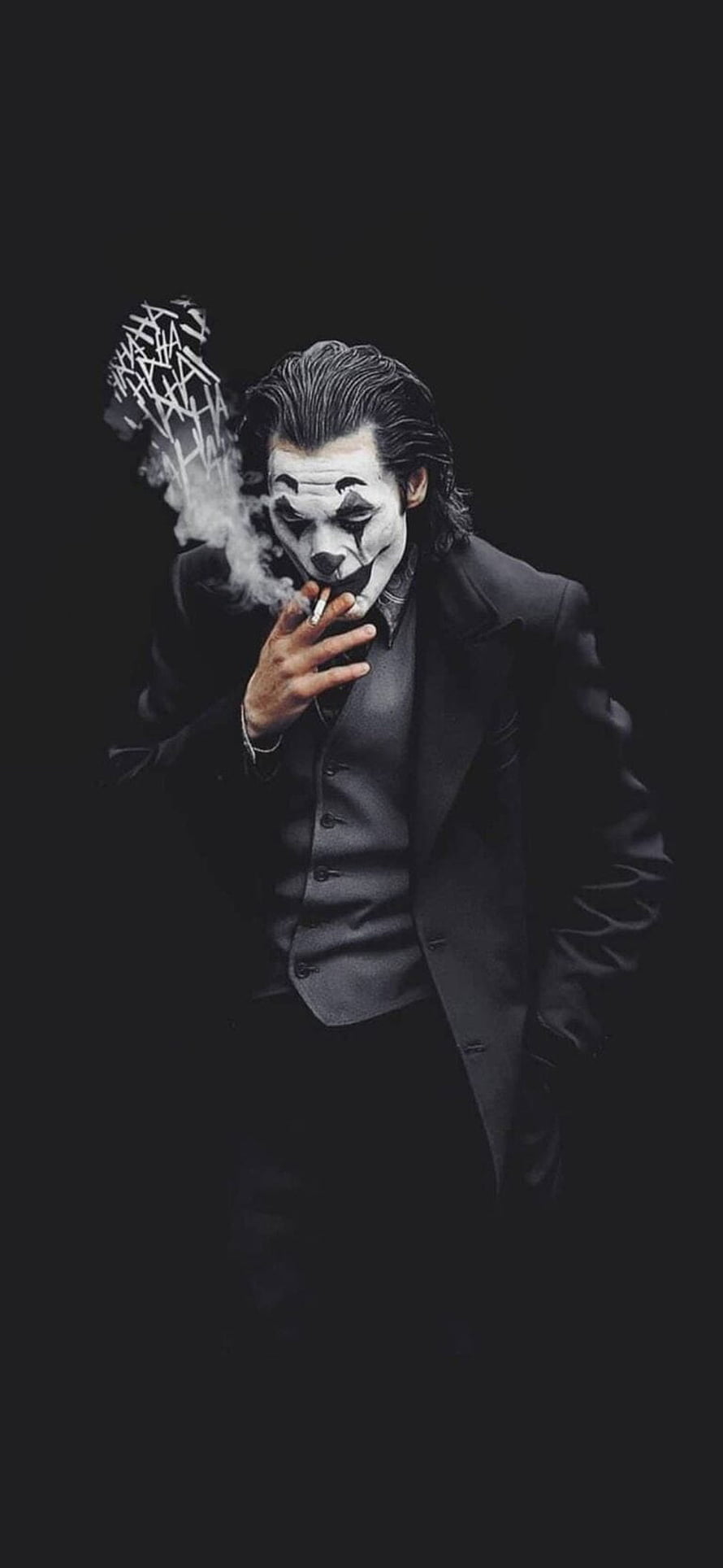 Joker in a black suit smoking a cigarette with dramatic smoke against a dark background HD phone wallpaper