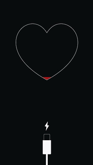 Minimalist iPhone Charging Screen with Sad Broken Heart Icon on Black Background HD phone wallpaper