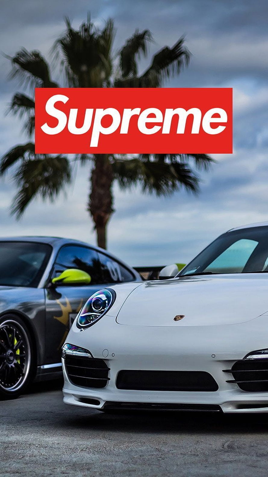 Supreme Logo Over White Porsche 911 and Grey Sports Car with Palm Tree Background HD phone wallpaper