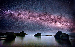 Milky Way Galaxy Arching Over a Serene Coastal Landscape at Night HD wallpaper