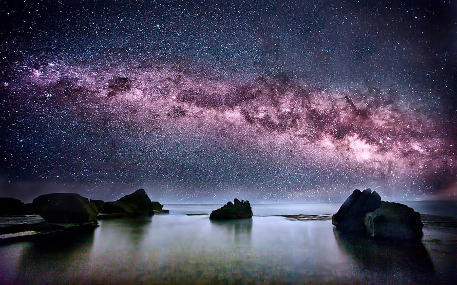 Milky Way Galaxy Arching Over a Serene Coastal Landscape at Night HD wallpaper
