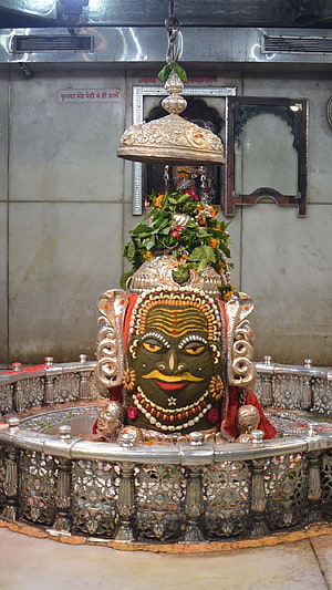 Sacred Khatu Shyam Ji Temple Idol with Silver Canopy and Floral Offerings HD phone wallpaper