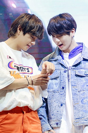 BTS V and Jin Sharing a Playful Moment in Casual Streetwear HD phone wallpaper