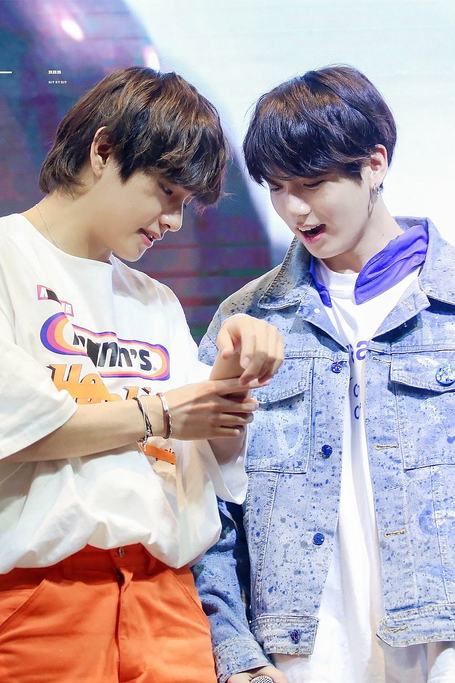 BTS V and Jin Sharing a Playful Moment in Casual Streetwear HD phone wallpaper