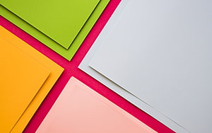 Colorful Paper Sheets Arranged on Pink Background HD wallpaper