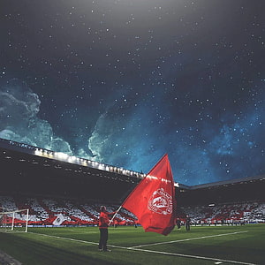 Manchester United Flag at Old Trafford Under a Starry Night Sky HD phone wallpaper
