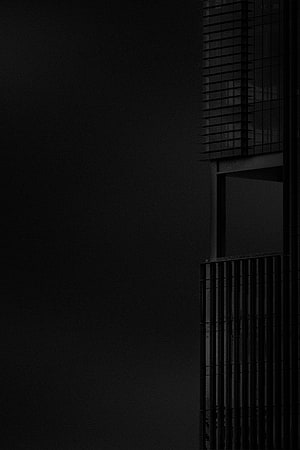 Minimalist Black and White Architectural Facade Against Dark Sky HD phone wallpaper