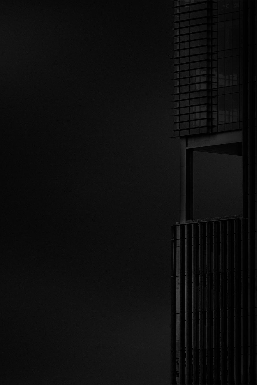 Minimalist Black and White Architectural Facade Against Dark Sky HD phone wallpaper