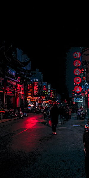 Neon-lit Chinese street at night with glowing red signs and pedestrians walking on wet pavement HD phone wallpaper