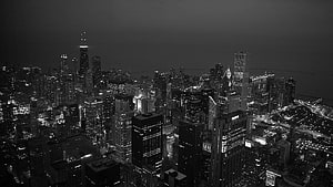 Monochrome Aerial View of Chicago Skyline at Night with Dense Urban Lights HD wallpaper