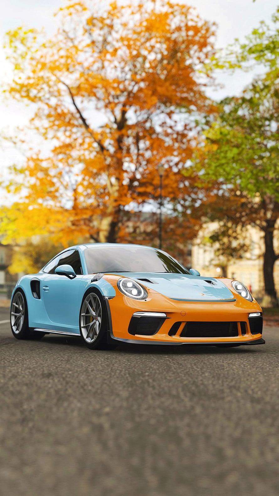Two-tone Porsche 911 GT3 in orange and blue parked on a street with autumn trees in the background HD phone wallpaper
