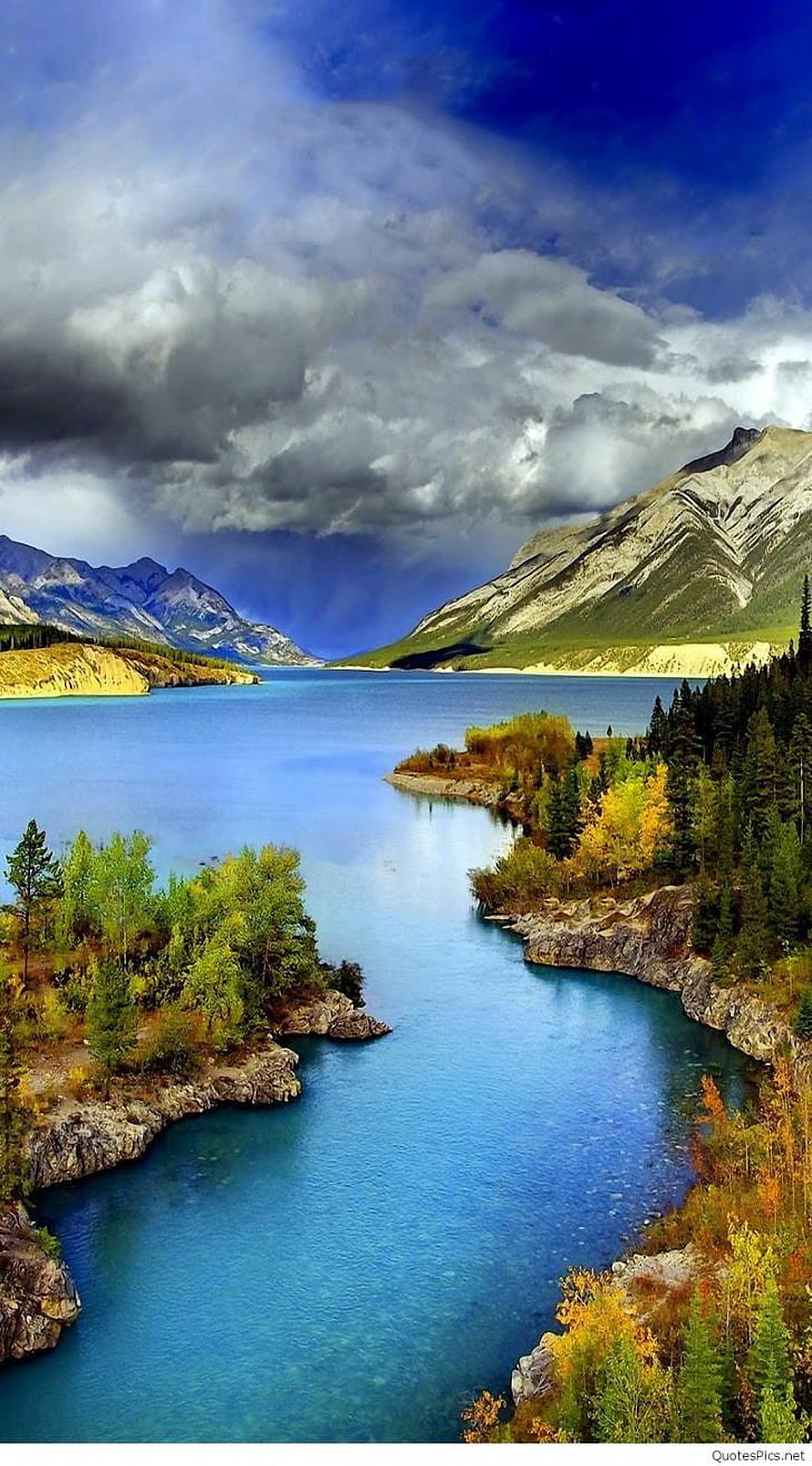 Majestic Alpine Lake with Turquoise Waters and Dramatic Cloudy Sky HD phone wallpaper