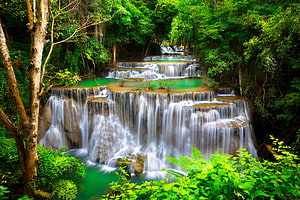 Lush tropical forest cascades with emerald pools and silky waterfall flow HD wallpaper