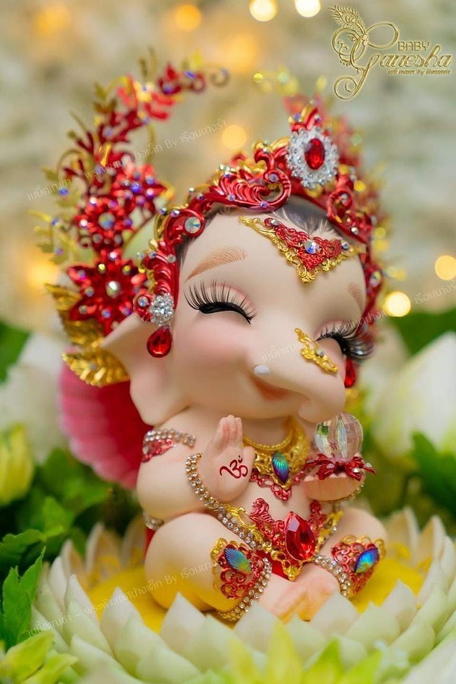 Adorable Baby Ganesha Statue with Red Jewels and Golden Crown Sitting on Lotus Flower HD phone wallpaper
