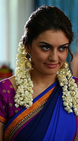 Hansika Motwani in a vibrant blue and purple saree with jasmine flower garlands and traditional gold jewelry HD phone wallpaper