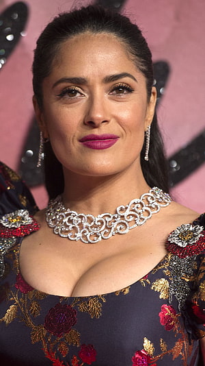 Salma Hayek in an ornate floral gown with a diamond necklace and statement earrings HD phone wallpaper