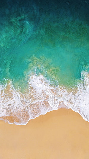 Aerial View of Turquoise Ocean Waves Crashing on Golden Sandy Beach HD phone wallpaper