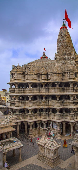 Ancient Dilwara Jain Temple Architecture with Intricate Stone Carvings and Red Flag HD phone wallpaper