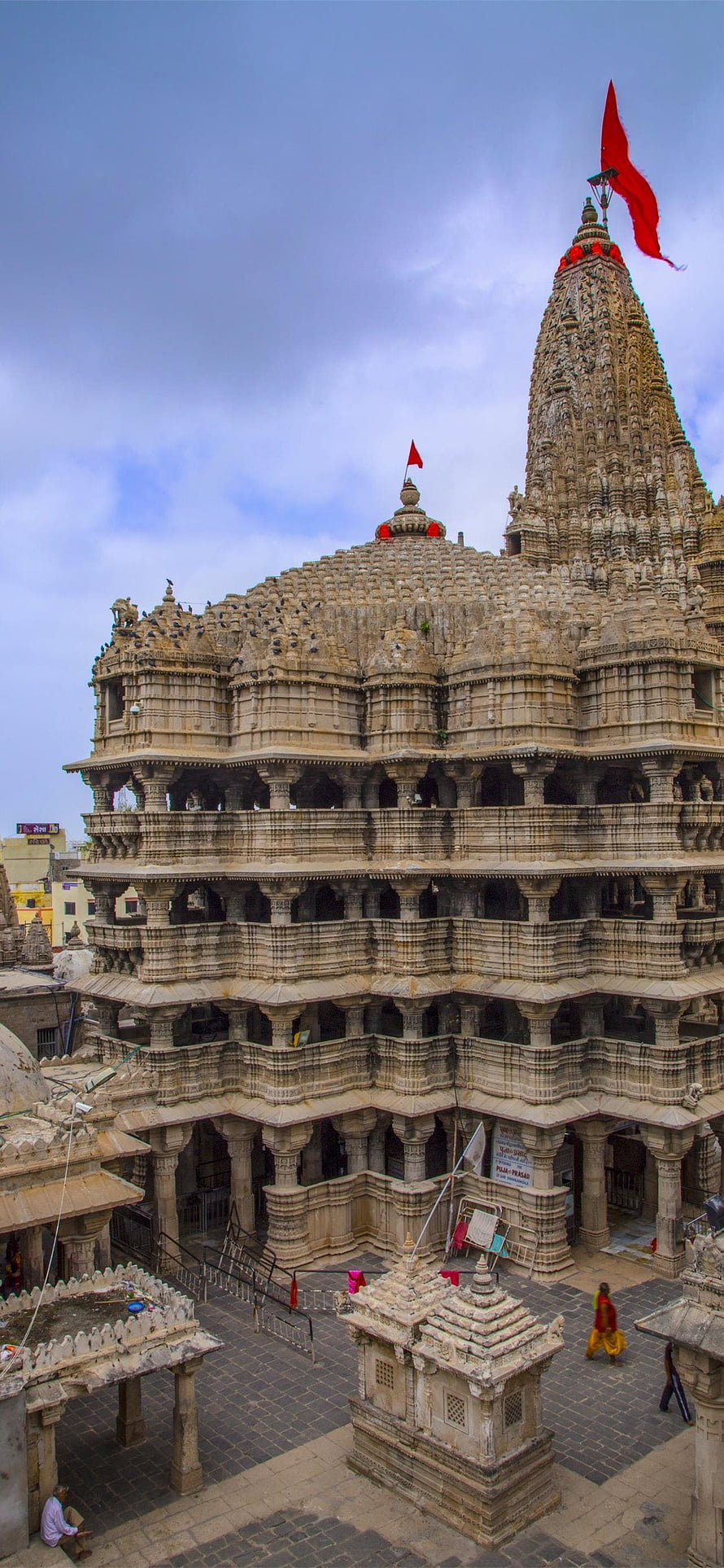 Ancient Dilwara Jain Temple Architecture with Intricate Stone Carvings and Red Flag HD phone wallpaper