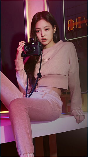 Jennie Blackpink in pink Adidas crop top and joggers holding a vintage camera under neon lighting HD phone wallpaper