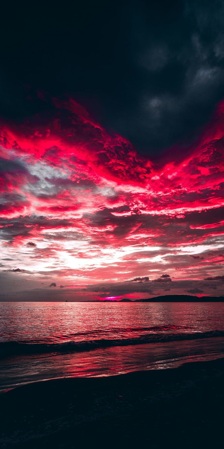 Dramatic Crimson Sunset Over Ocean With Vibrant Red Clouds And Dark Silhouette HD phone wallpaper